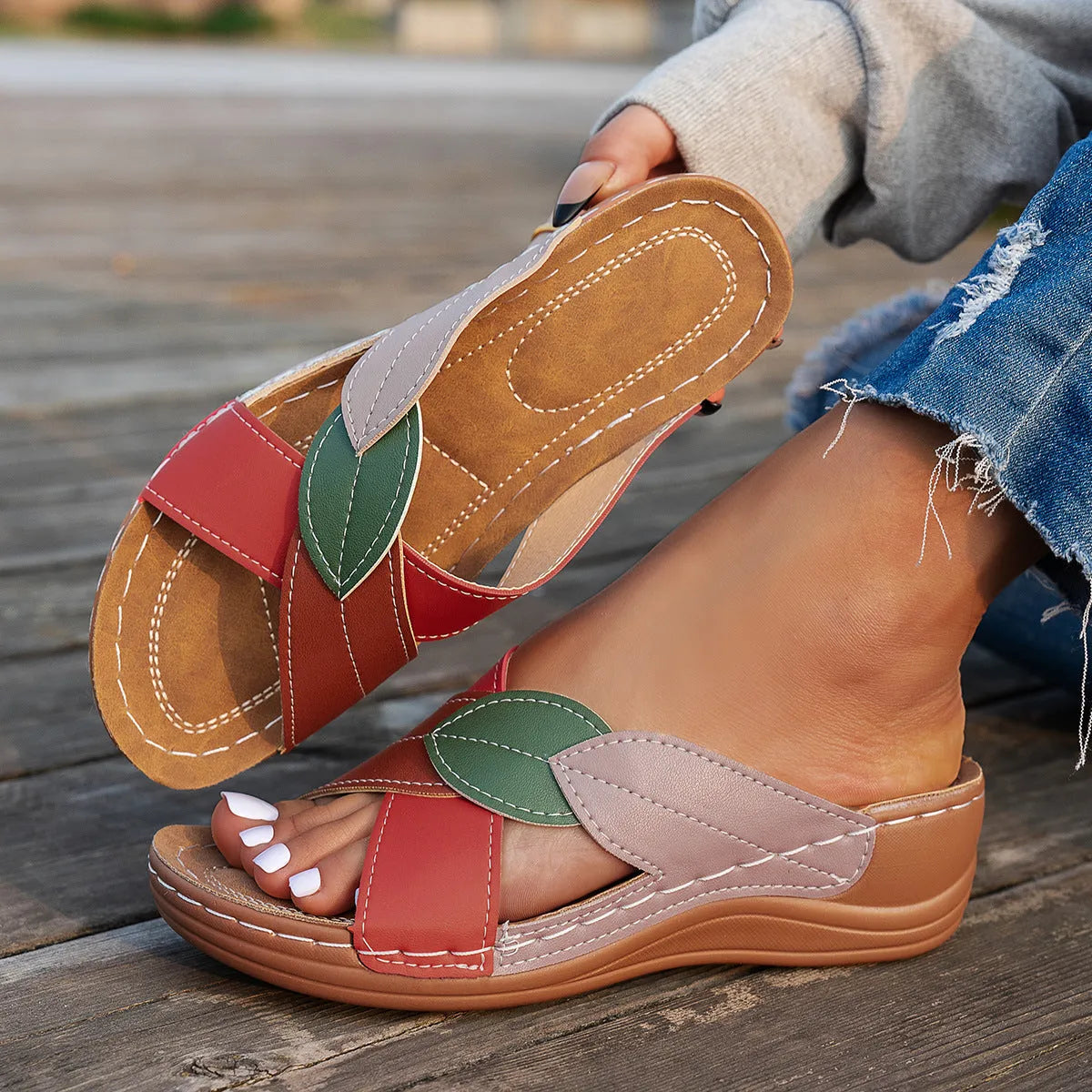 Women's black thick-soled slippers with a cross-strap and peep-toe fish-mouth design on a white background.