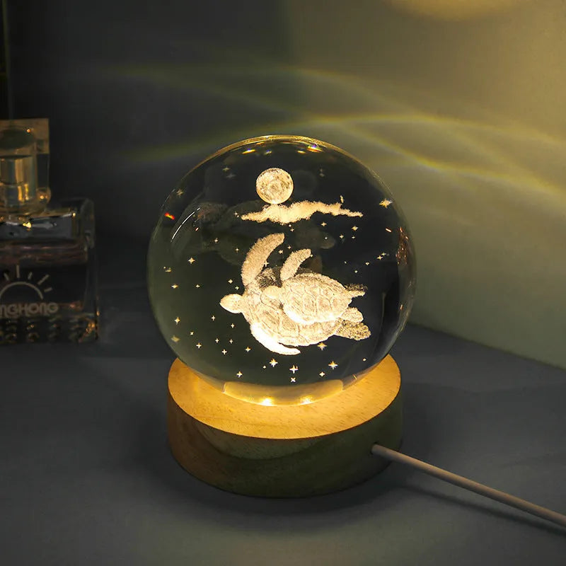 Transparent crystal ball night lamp with 3D carved jellyfish design, on a round base with USB cable.