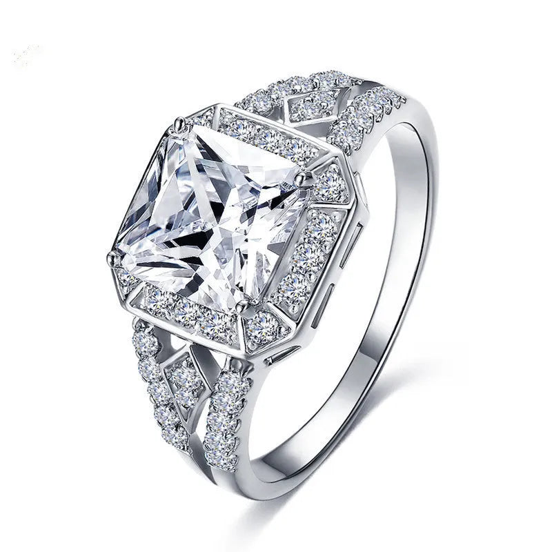 Women's platinum colour geometric zircon ring with hollow quadrilateral design on a copper band.