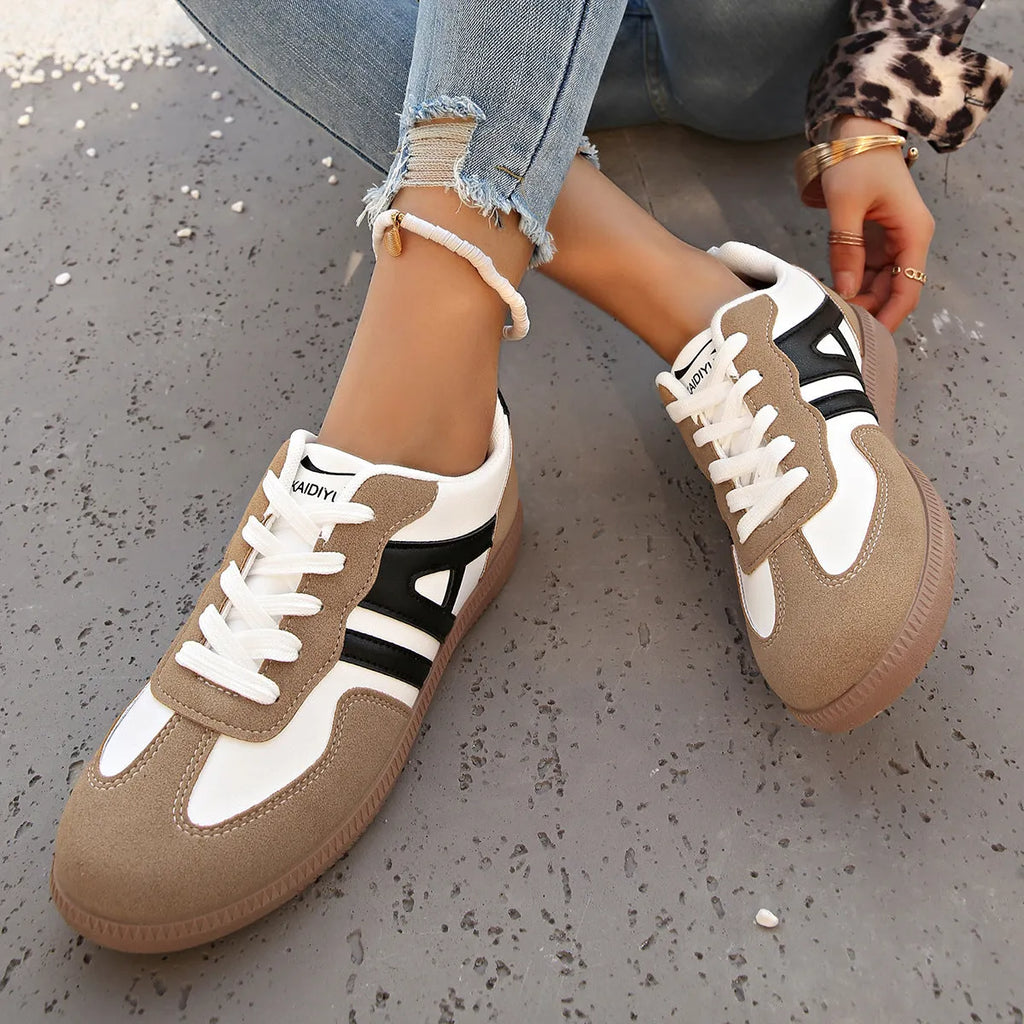 Women's retro colour matching lace-up jogging shoes in black, showing low-top design and platform heel.