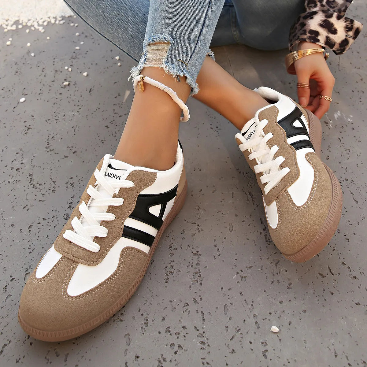 Women's retro colour matching lace-up jogging shoes in black, showing low-top design and platform heel.