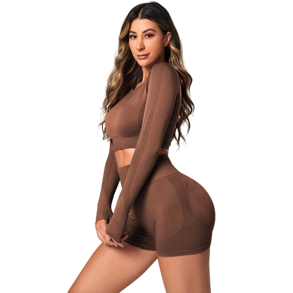 Women's high-waisted yoga suit set in black, featuring a long-sleeved top and tight leggings.