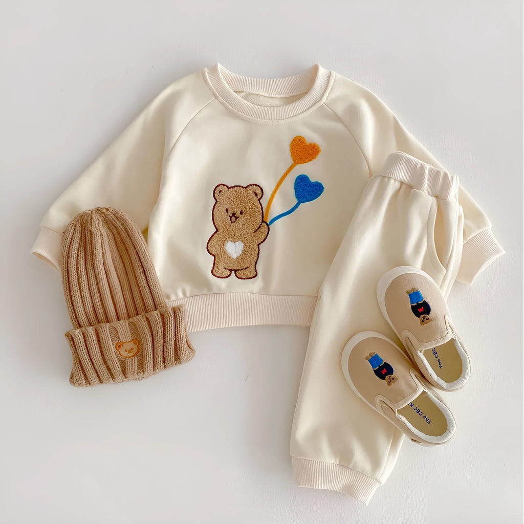 Baby suit in light beige with cute bear ball pattern, long-sleeved sweater and matching trousers, cotton fabric