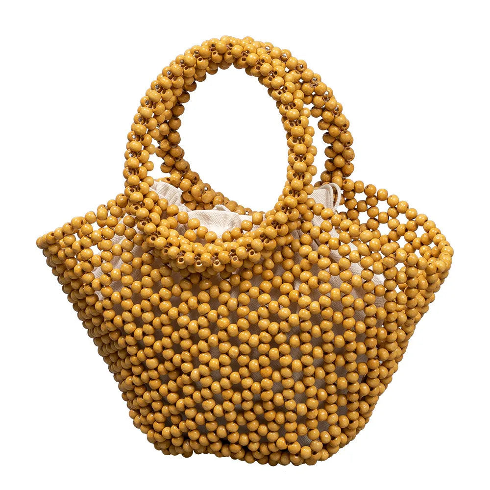 Hand-woven dumpling-shaped maple beach handbag with wooden bead decoration in milky white colour