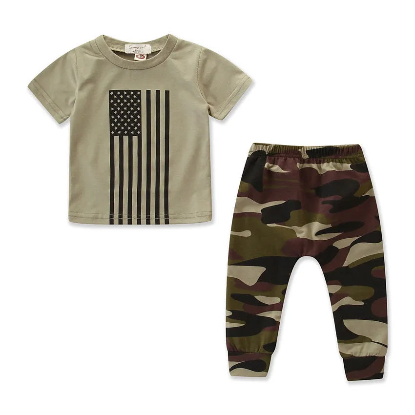 Little boy wearing a US flag camouflage print short-sleeved shirt and matching trousers.