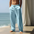Man wearing grey loose-fit cotton casual trousers with an elastic waistband.