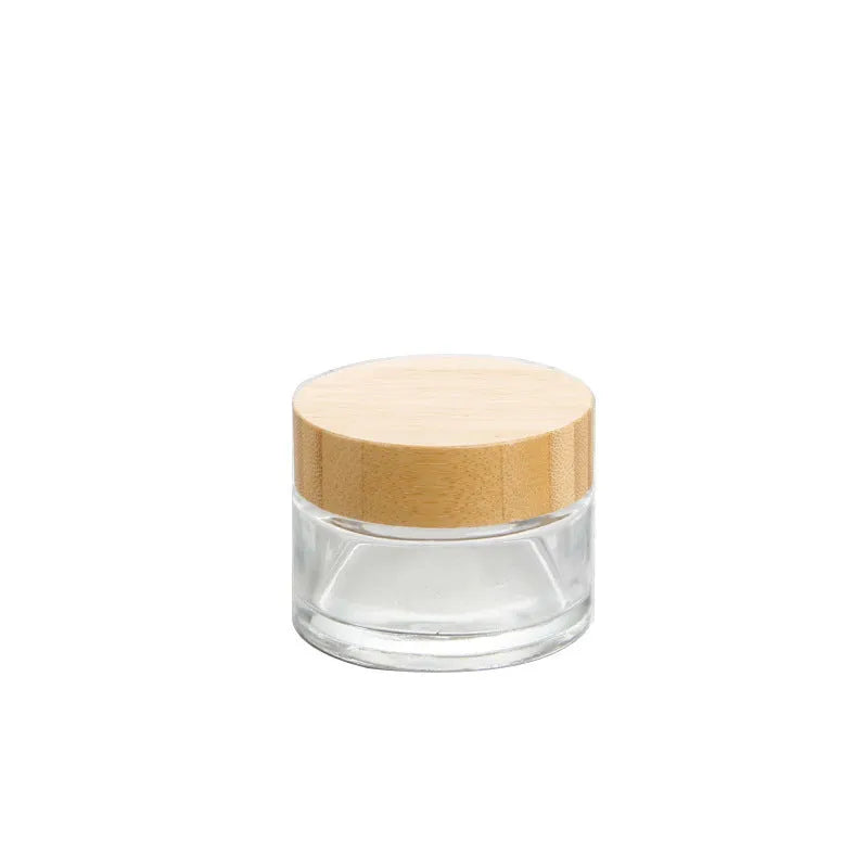Refillable glass cream jar with bamboo wood lid, transparent finish, 100g capacity