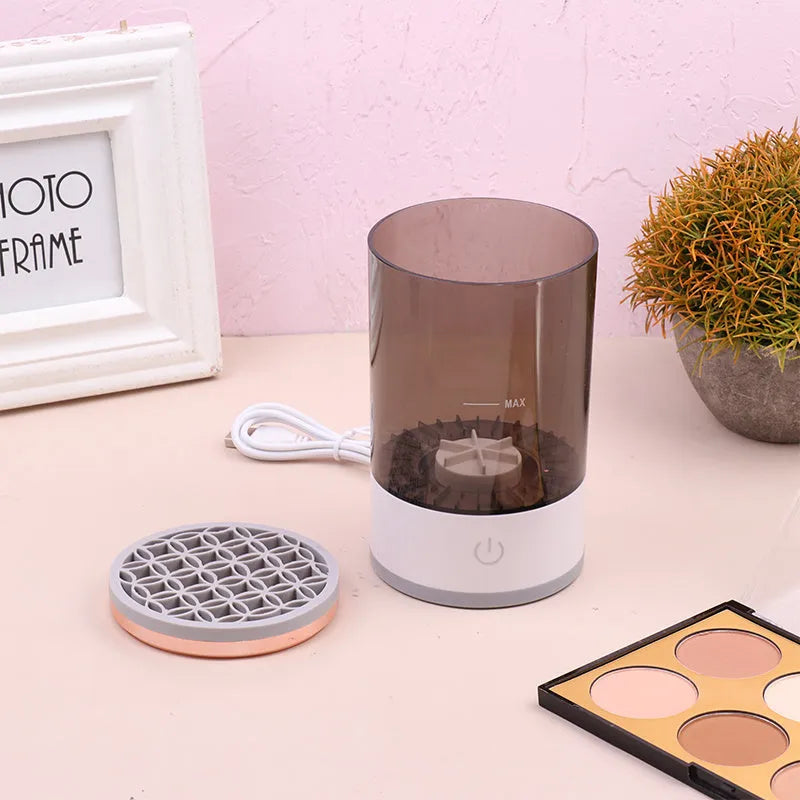 Electric makeup brush cleaner in grey and white with brush inserted, 17x9x9 cm, USB charging