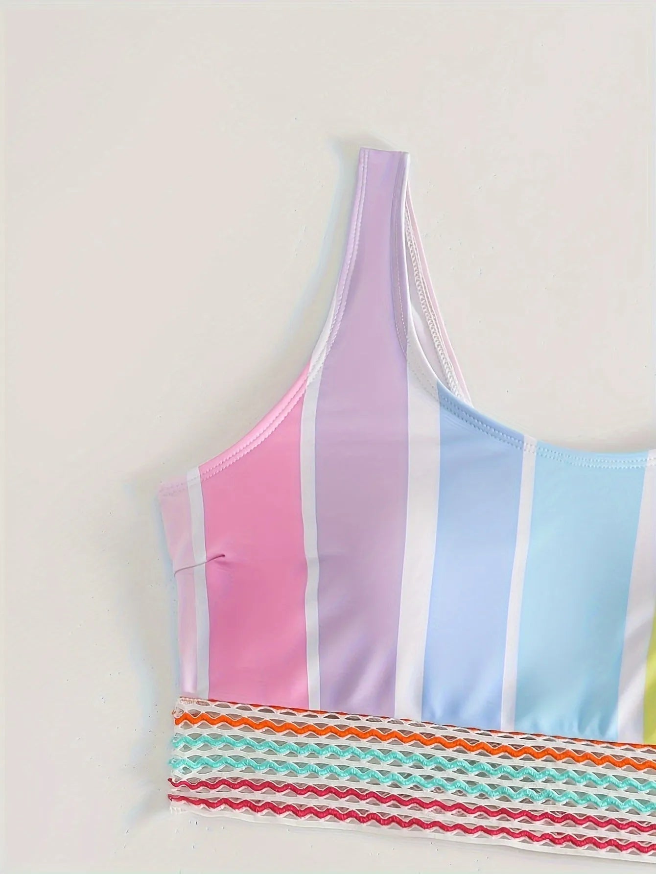 Women's striped bikini top and briefs set on a mannequin, showing the European-American style brief cut and spandex lining.