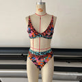 Women's floral print high-waisted bikini swimsuit set on a mannequin.