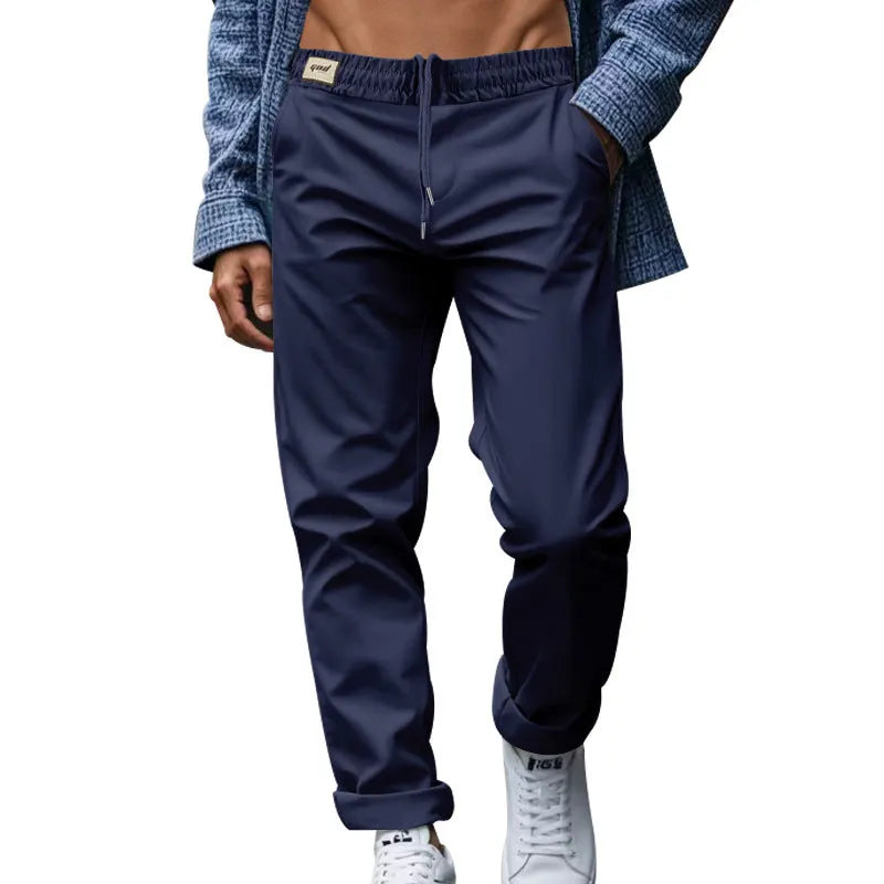 Men's casual trousers in solid grey, loose fit with drawstring waist and side pockets, full length