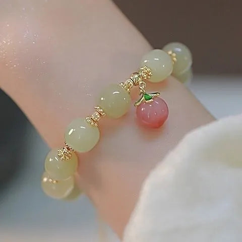 Handmade unisex glass beaded bracelet with rabbit charm on elastic cord.