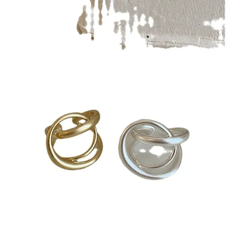 Geometric open ring with interlaced matte metal construction in gold and silver plating options