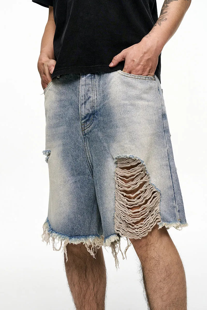 Light blue washed denim shorts for men with a baggy fit and mid waist, shown on a hanger.