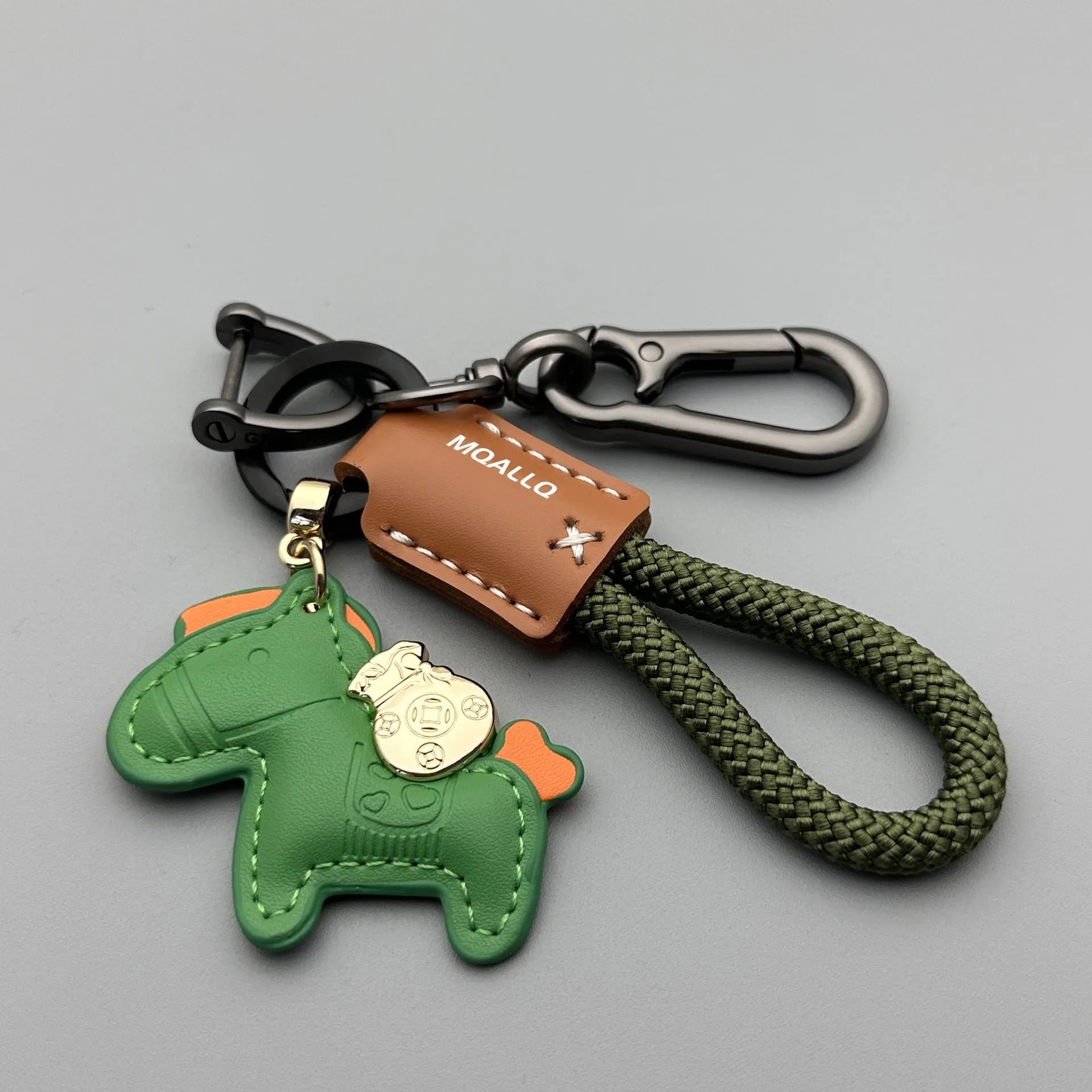 Handmade brown cowhide key ring pendant with zinc alloy pony buckle and green flanelle rope.