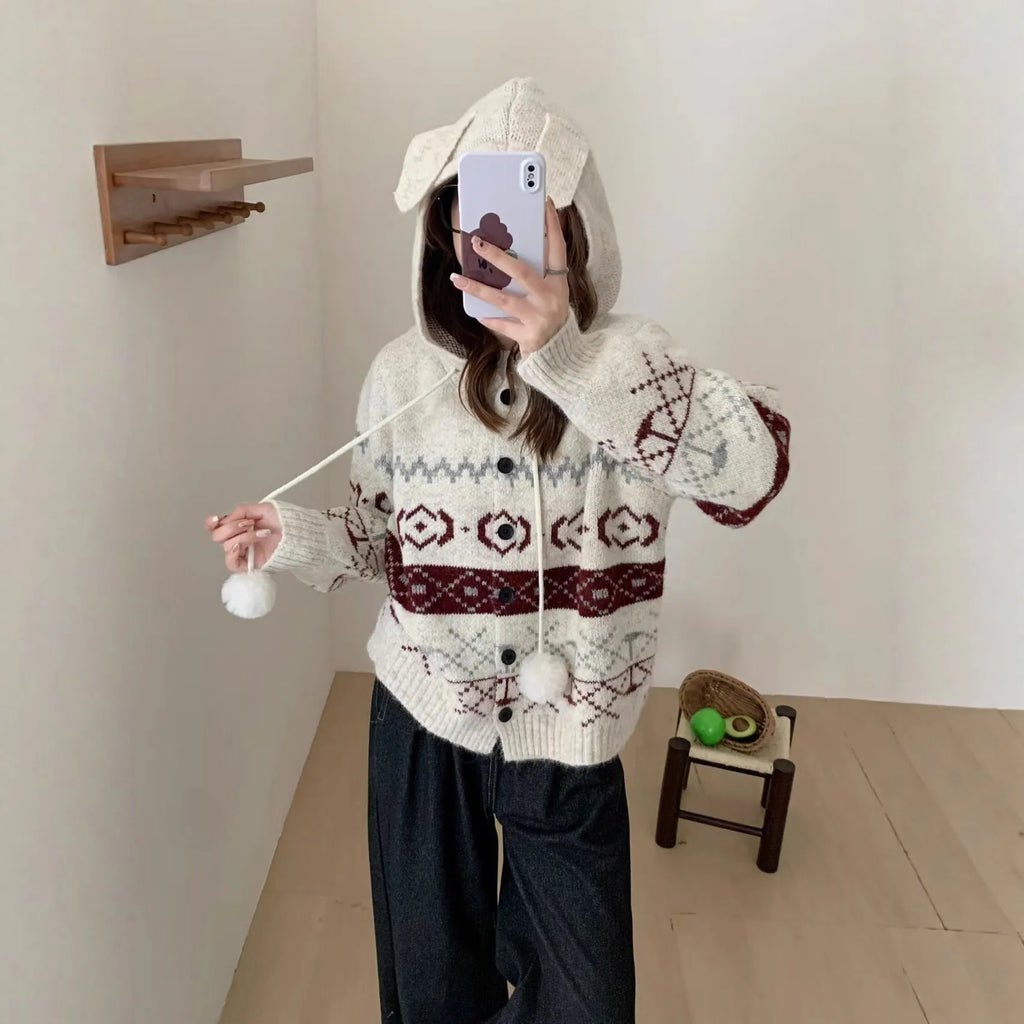Plus size woman wearing a loose milky white geometric brocade sweater coat with long sleeves.