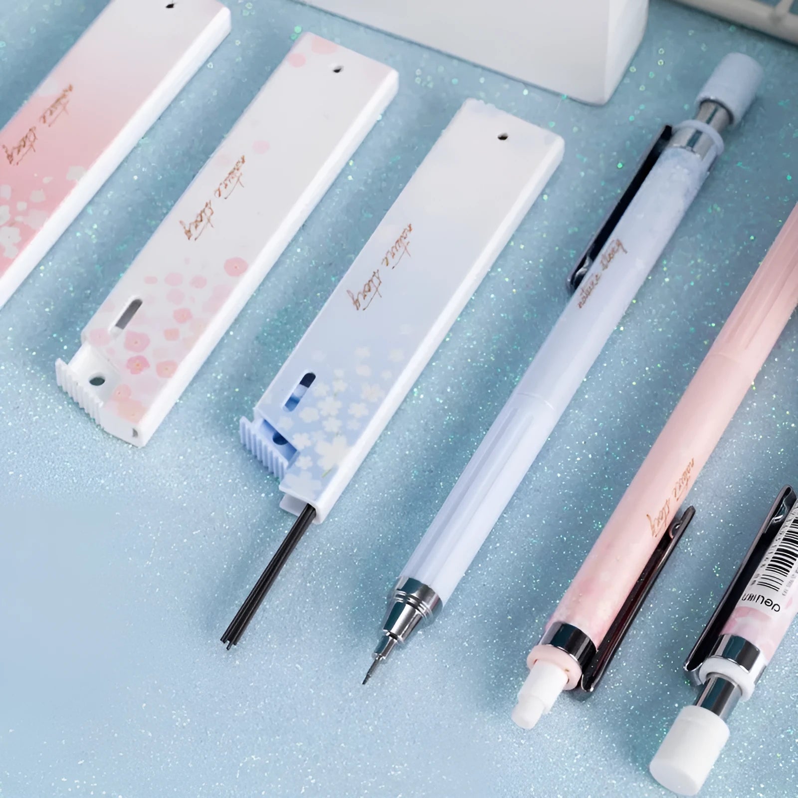 Cartoon style 0.5mm automatic pencil set with three pencils and three HB lead refill boxes.