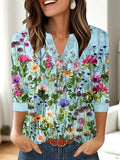 Women's loose grey V-neck t-shirt with a colourful 3D geometric pattern on the front.