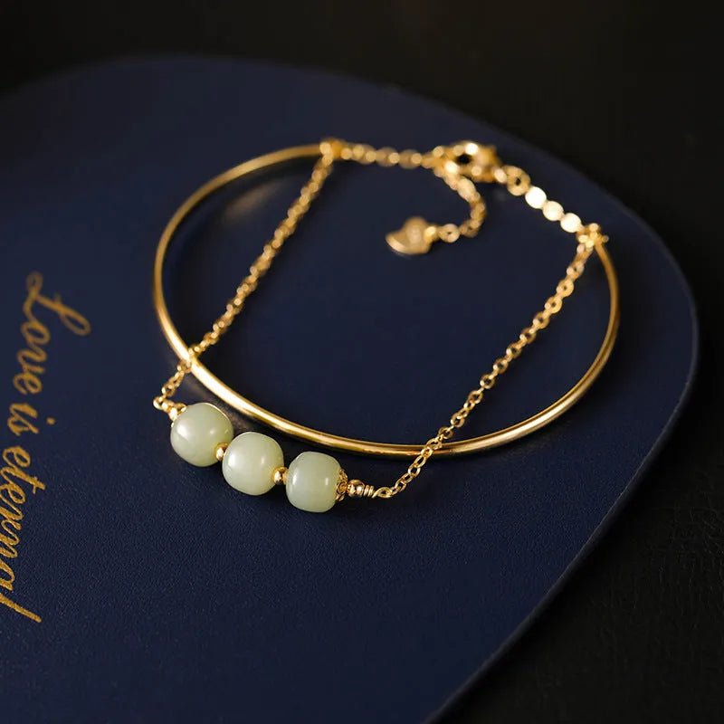 Women's Hetian jade bracelet with gold inlay design in single, double, or three-bead versions.