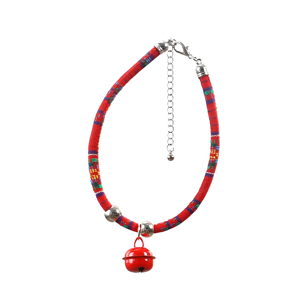 Coloured ethnic-pattern adjustable dog or cat collar with a small metal bell attached, shown in pink.