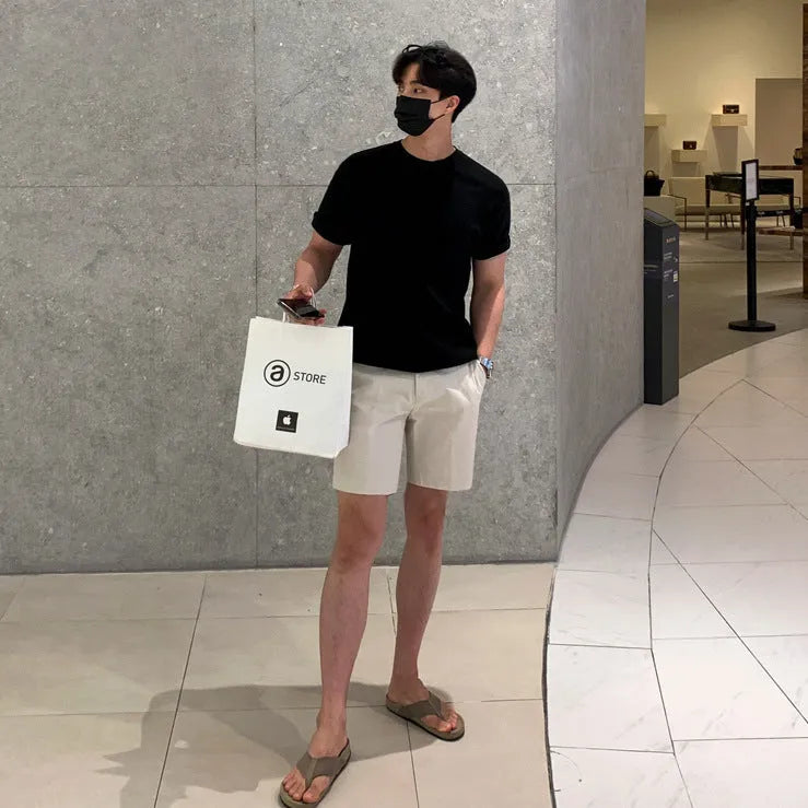 Men's straight-leg casual shorts in solid black, shown laid flat, featuring a non-iron polyester fabric.