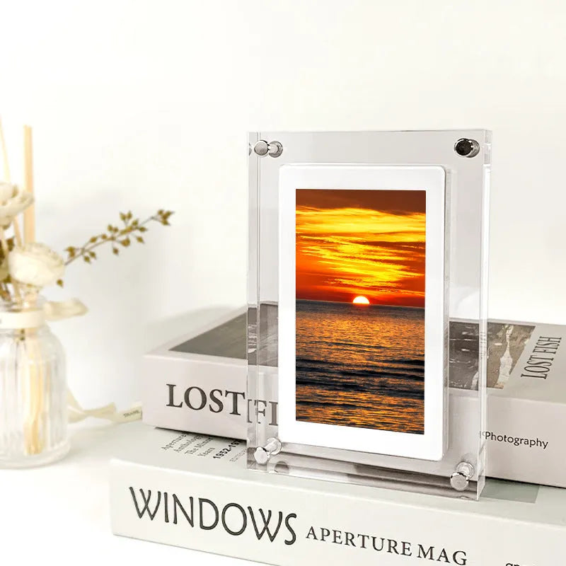 White acrylic digital photo frame with 5-inch vertical screen showing family photos