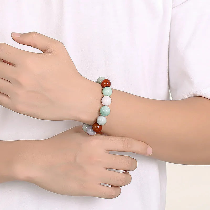Women's bracelet with round three-colour jade beads, certificate visible.