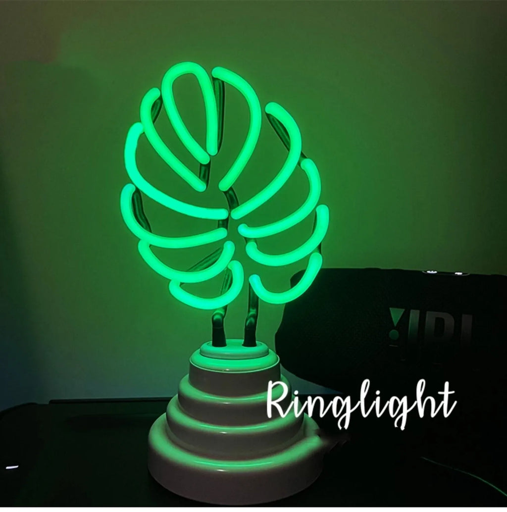 White minimalist bamboo-shaped desk lamp with green light, showing large and small size options.