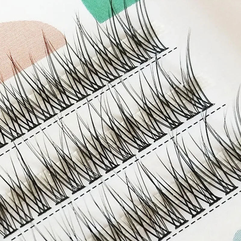 Black V-shaped fairy fishtail false eyelashes with thick segments in varying lengths on a clear band.