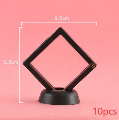 3D floating display case holding a coin suspended between transparent membrane sheets, black frame