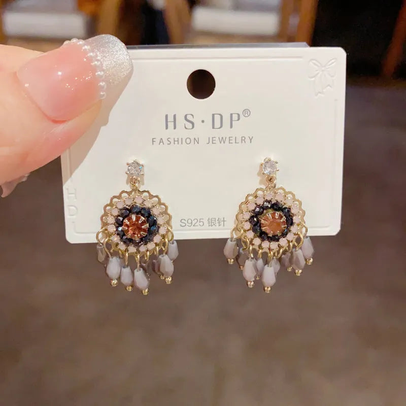 Women's round crystal tassel earrings with embedded diamonds in blue and purple geometric designs