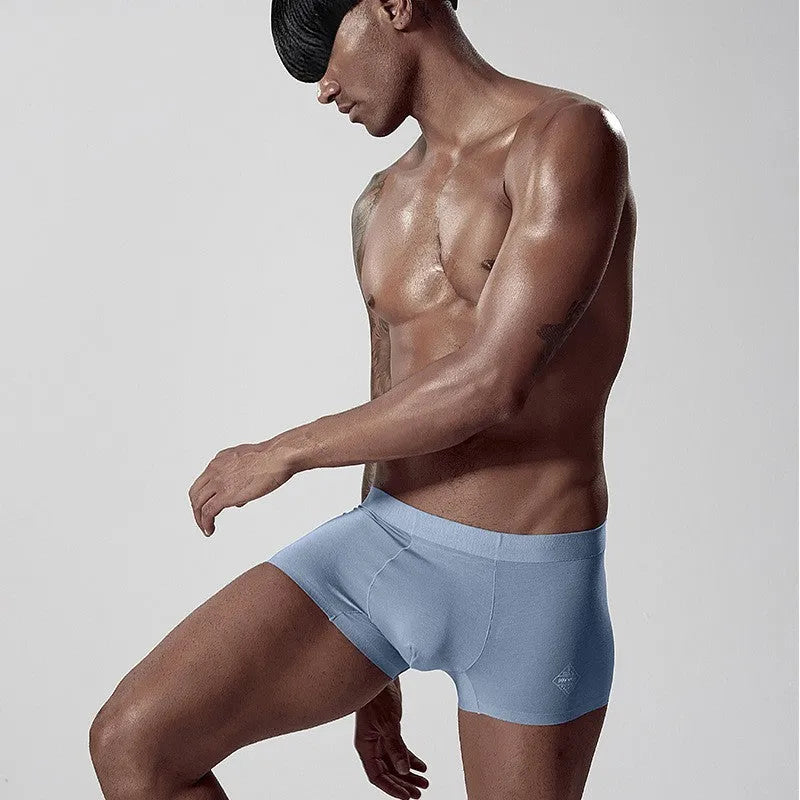 Men's seamless modal one-piece underwear in white, pink, or green with mid-waist hip lifting design