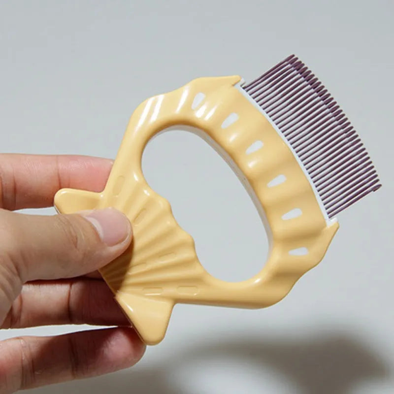 Shell-shaped plastic pet grooming comb with bent wire bristles in green, orange, or purple colours.