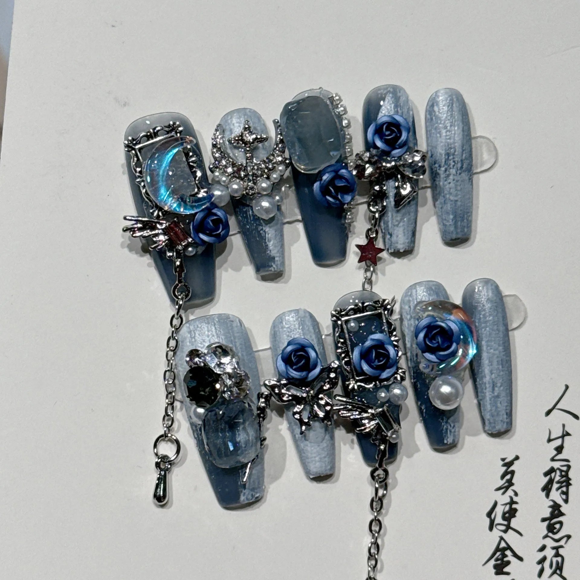 Heavy industry blue night manicure set with rose and tulip floral designs on plastic armour suit.