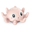 Blue and pink automatic spray octopus bath toy with flashing lights next to its colour box packaging.