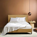 Four-piece imitation silk bedding set with satin weave in Navy Blue on a bed