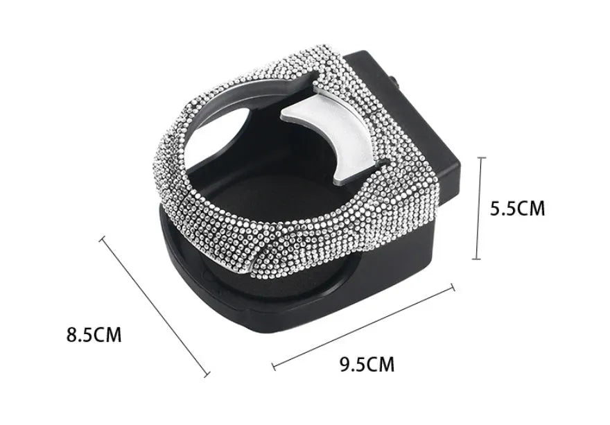 Rhinestone-encrusted white car cup holder bracket mounted on a vehicle air vent.