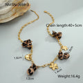Stainless steel necklace with a geometric leopard pendant and heart and flower accents on an adjustable chain.
