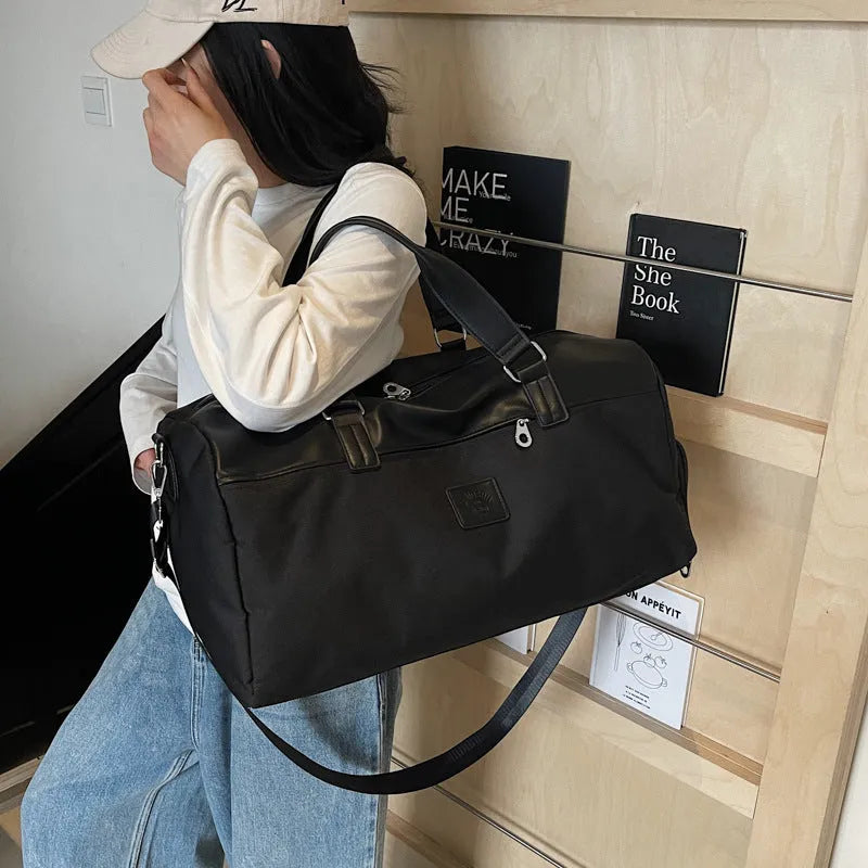 Large black messenger bag made from oxford cloth with a 55-litre capacity.