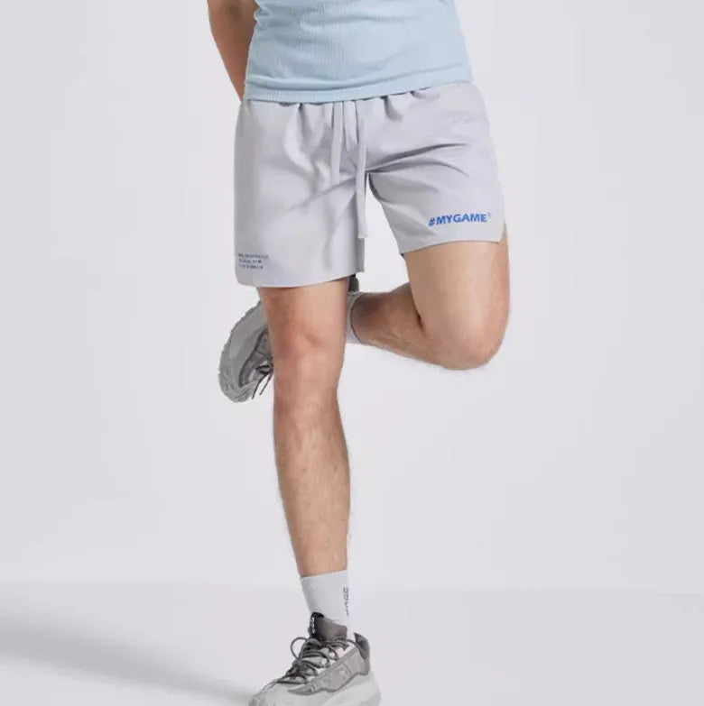 Men's navy blue training shorts with moisture-wicking fabric on a grey background.