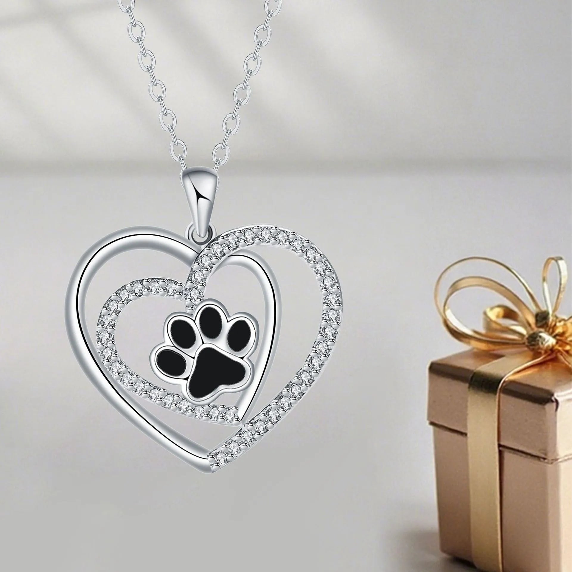 Women's copper necklace with dog paw print and heart detail pendant on cross chain.