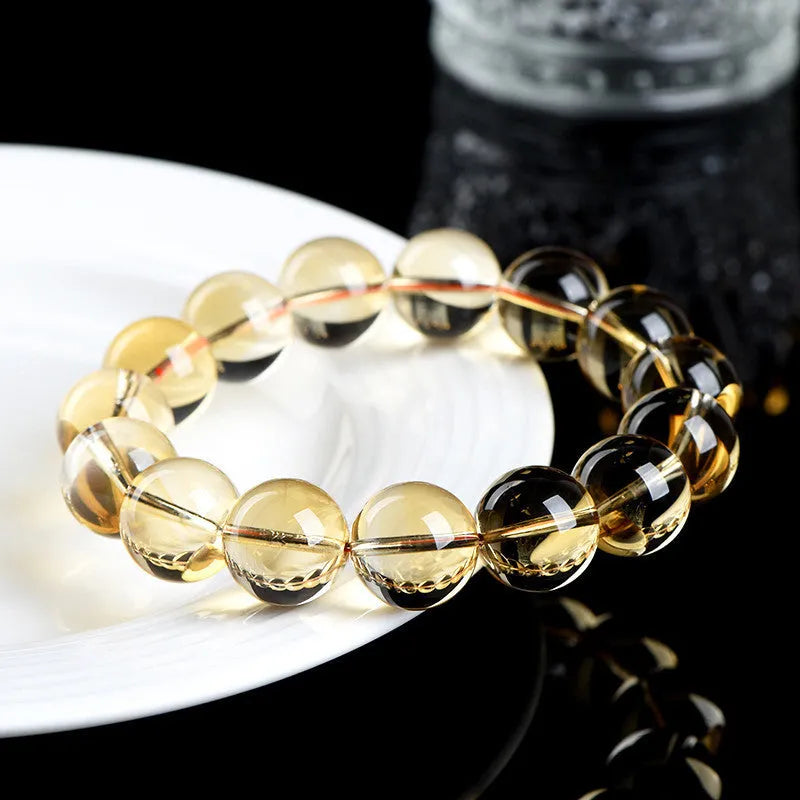 Natural honey-yellow citrine bead bracelet with hand-knotted cord, shown in scattered bead style.