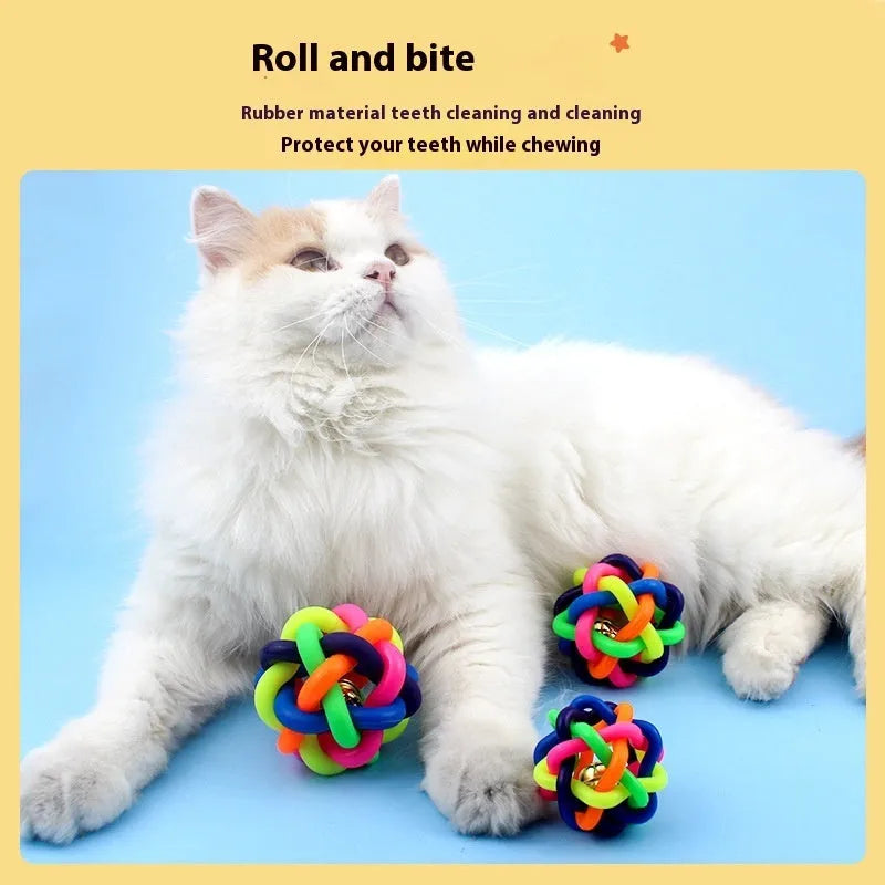Colourful woven plastic pet toy ball with bell in rainbow colour on white background