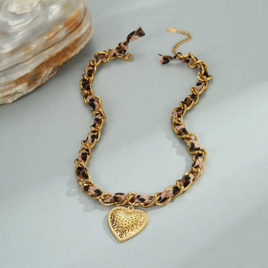 Geometric leopard love pendant necklace on a stainless steel chain with 18K gold electroplate.