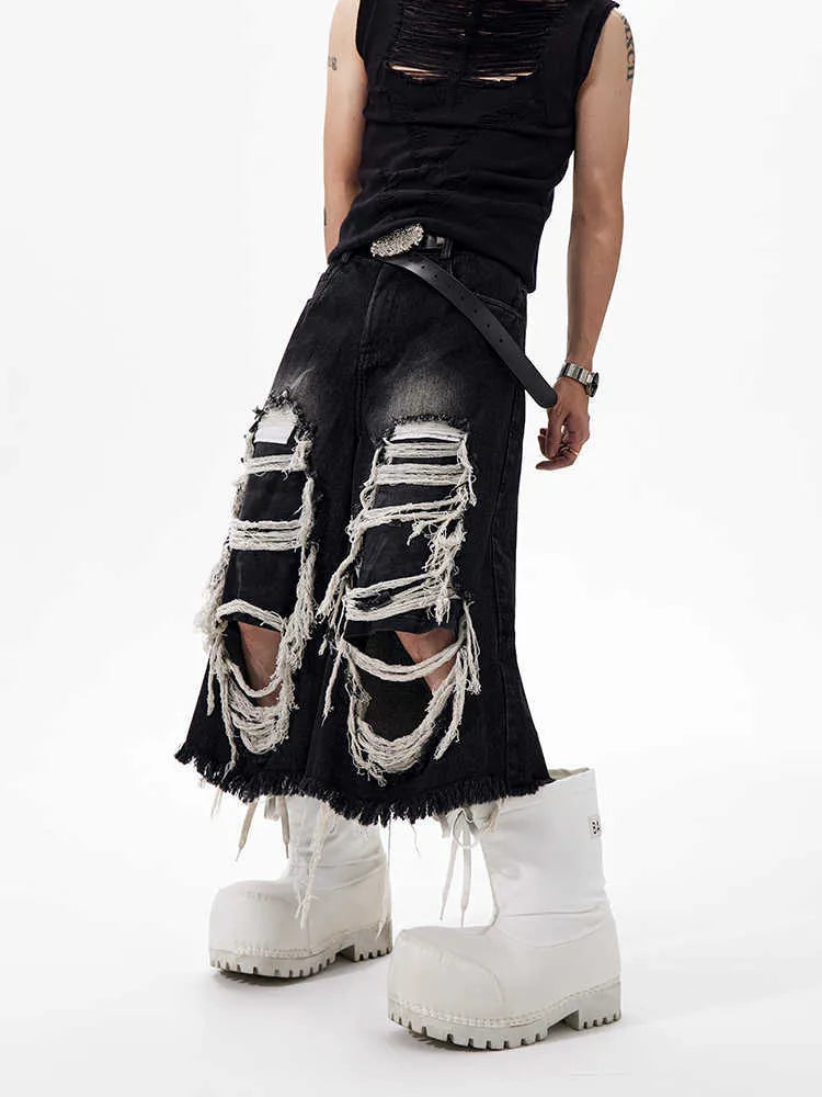 Black cropped wide-leg jeans with ripped patch details and mid-high waist