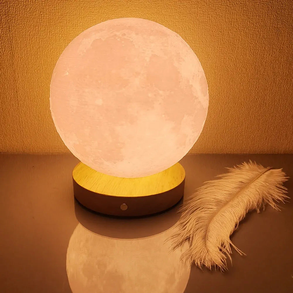 Rotating moon night lamp on a wooden base showing three colour light modes.