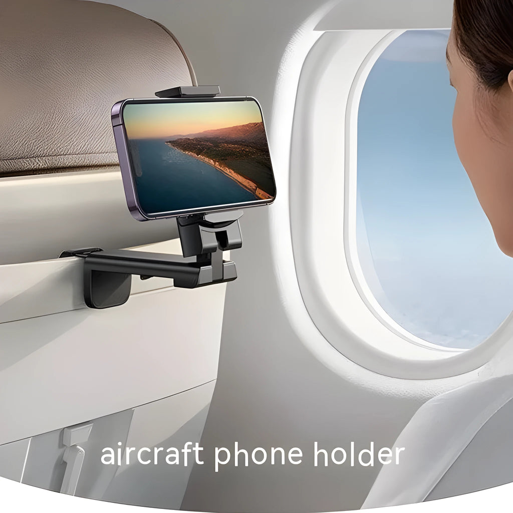 Black foldable rotating universal phone holder made of ABS plastic on a table.