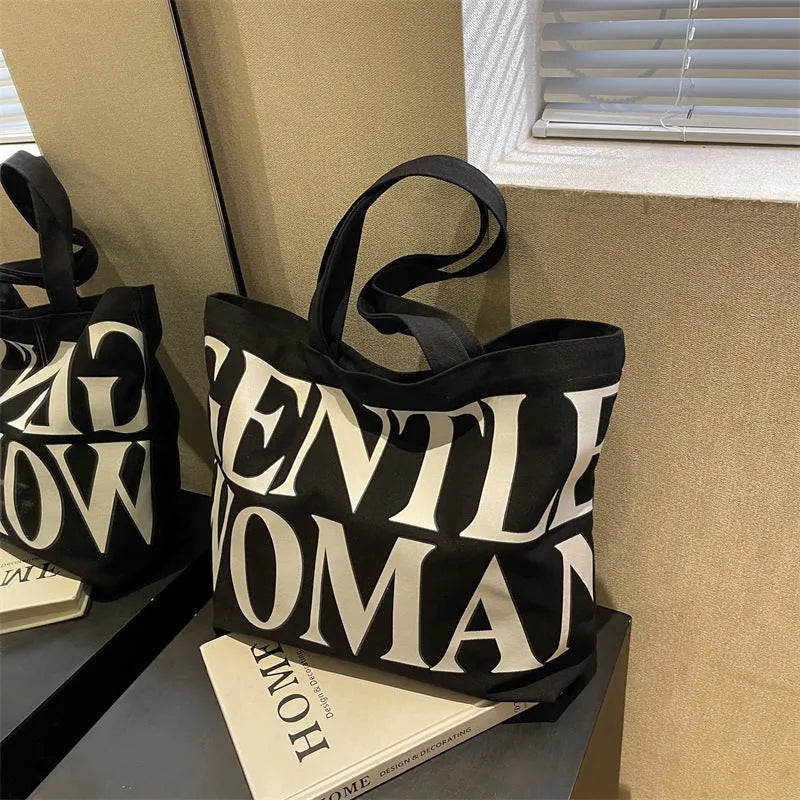 Large capacity canvas tote bag with letter print and upgraded zipper, off-white colour, on plain background