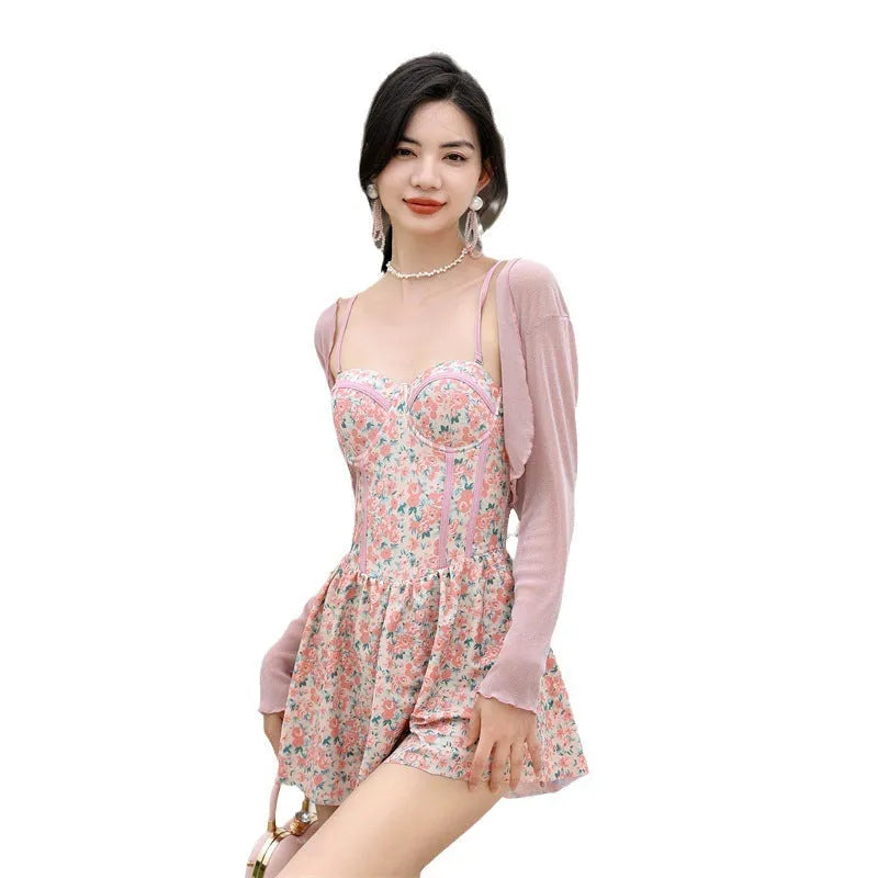 Women's pink floral one-piece jumpsuit swimsuit with suspender straps on hanger