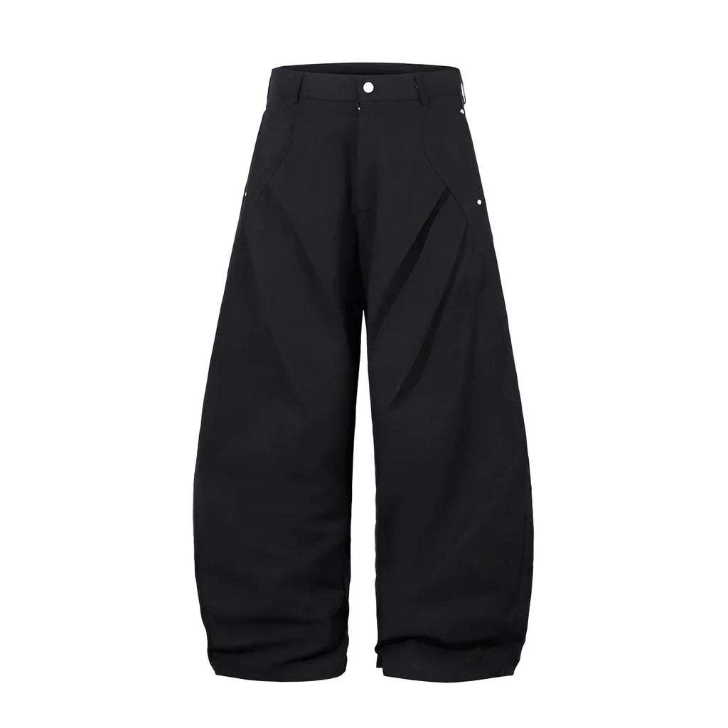 Men's black pleated wide-leg cotton trousers showing loose-fitting casual design